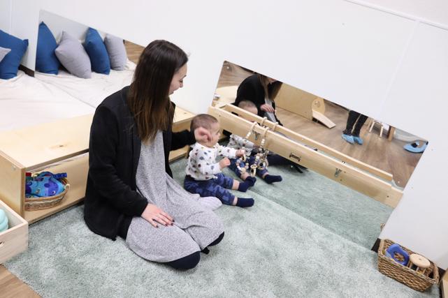 Nido baby grasping beads that help him with his psychomotor development at Guidepost Montessori in Frisco, TX | Private School