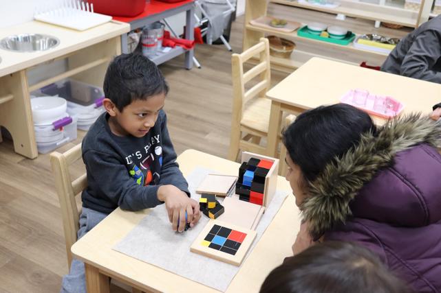 Student impresses his mom with the construction of the trinomial cube! This is the physical construction of the cube of a trinomial, (a+b+c)^3 at Guidepost Montessori at Stonebriar, Frisco tx