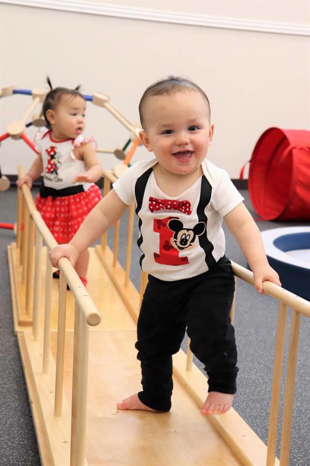 Nido students turn 1 years old working on their balance and gross motor skills at Guidepost Montessori in Frisco, TX